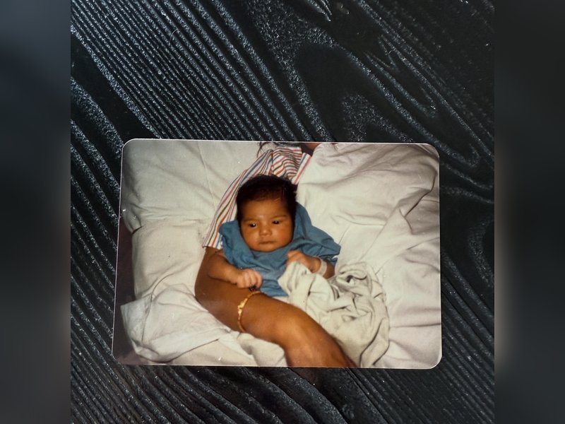 Karan Tacker as a newborn nestles in his mother’s arms in a throwback childhood picture	