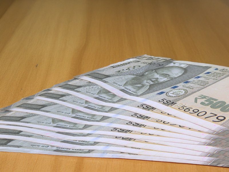 Rupee slides over weak global cues, FII outflows