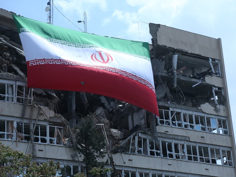 Tehran: This photo taken on April 20, 2026 shows a national flag of Iran hanging on a building damaged by the U.S.-Israeli attacks in Tehran, Iran. (Xinhua via IANS)