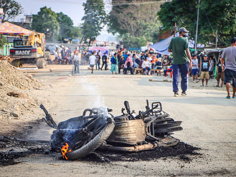 Imphal West: A motorcycle lies burnt during the final day of a three-day total shutdown at Namdilong Village, Kanglatombi, Imphal West, on Thursday, April 23, 2026. The shutdown is called by the United Naga Council in protest against the killing of two Tangkhul Naga men in the Ukhrul district. (Photo: IANS)