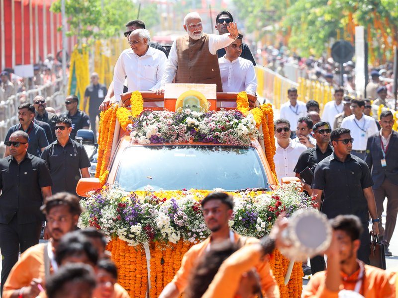 Gir Somnath: Prime Minister Narendra Modi, along with Gujarat Chief Minister Bhupendra Patel and Gujarat Deputy Chief Minister and state minister Harsh Sanghvi, holds a roadshow during his visit to Somnath in the Gir Somnath district of Gujarat on Monday, May 11, 2026. (Photo: IANS/PMO)