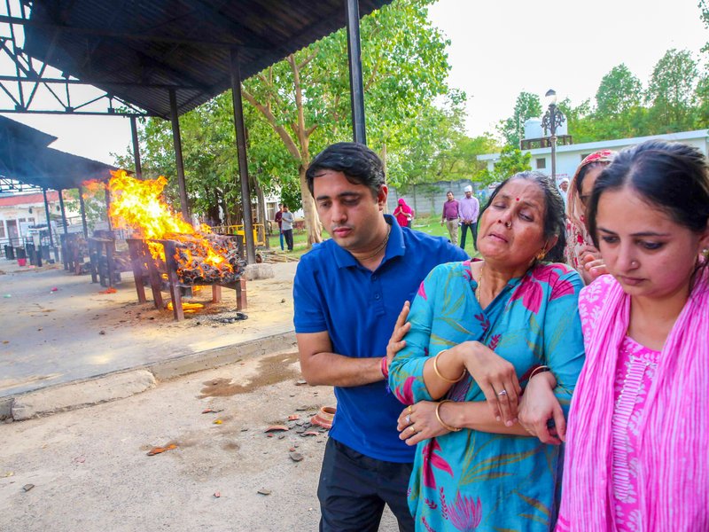 Bhopal: Relatives console the mother of Twisha Sharma during her last rites at Bhadbhada cremation ground in Bhopal on Sunday, May 24, 2026. (Photo: IANS)