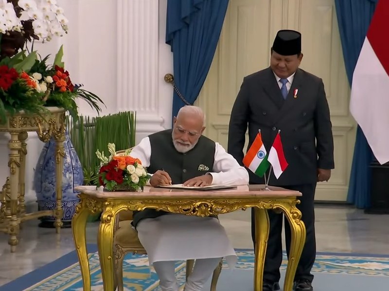 PM Modi signs guestbook upon meeting Indonesian Prez Subianto at Istana Merdeka