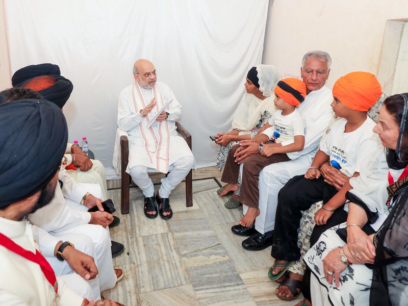 Mansa: Union Home Minister Amit Shah and Punjab BJP President Kewal Singh Dhillon meet the family of slain anti-drug activist Parvinder Singh Jhota at his residence in Mansa, Punjab, on Tuesday, October 20, 2026. (Photo: IANS/X/@AmitShah)