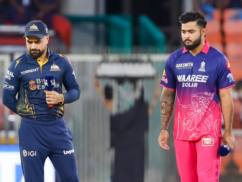 Rashid Khan leads Gujarat Titans in Shubman Gill’s absence; Kumar Kushagra earns debut as RR opt to bat. Photo credit: IANS 