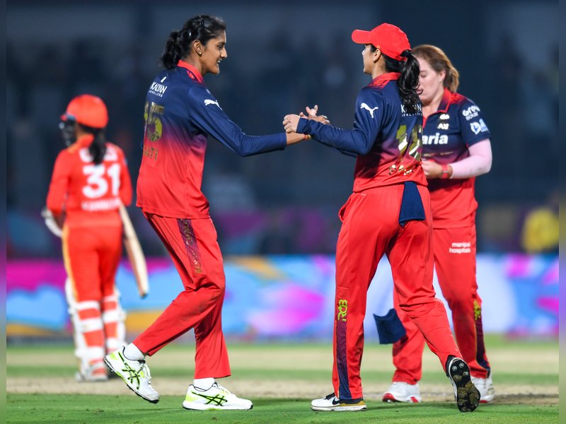 Sayali Satghare’s three-for helps Royal Challengers Bengaluru book playoffs spot with massive win over Gujarat Giants in the Women’s Premier League (WPL) at Kotambi Stadium in Vadodara on Monday. Photo credit: IANS